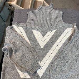 Two cold shoulder turtle neck sweaters